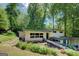 Two-story home with inviting walkway to the entrance, set in a serene environment of mature trees and plants at 3449 Archwood Dr, Doraville, GA 30340