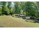 Two-story home with expansive lawn, mature trees, and side-entry garage, offering a serene living environment at 3449 Archwood Dr, Doraville, GA 30340
