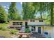 Inviting front entrance with a charming walkway and lush garden beds. A tranquil chair sits near the entry at 3449 Archwood Dr, Doraville, GA 30340