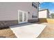 A simple, concrete patio extending from the home, situated in a fenced-in backyard with light brown siding at 3460 Sycamore Sw Dr, South Fulton, GA 30331