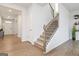 Bright entryway boasts wood floors and staircase with wooden handrail at 3460 Sycamore Sw Dr, South Fulton, GA 30331