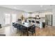 Spacious eat-in kitchen featuring modern appliances, granite countertops, a large island, and a dining area with seating at 3460 Sycamore Sw Dr, South Fulton, GA 30331