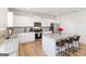 Modern kitchen with stainless steel appliances, granite countertops, white cabinets, and an island with barstool seating at 3460 Sycamore Sw Dr, South Fulton, GA 30331