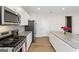 Well-equipped kitchen featuring stainless steel appliances, granite countertops, white cabinets, and an island at 3460 Sycamore Sw Dr, South Fulton, GA 30331