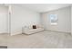 Spacious living room with neutral carpet, a white couch, and a bright window, creating a calming atmosphere at 3460 Sycamore Sw Dr, South Fulton, GA 30331