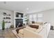 Inviting living room with a fireplace, a large sectional sofa, decorative shelves, and plenty of natural light from the windows at 3460 Sycamore Sw Dr, South Fulton, GA 30331