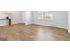 Bright room with wood-look floors and a large window, offering a versatile space for various uses and ample natural light at 3460 Sycamore Sw Dr, South Fulton, GA 30331