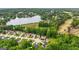 Aerial view of a neighborhood near a lake, with homes neatly arranged in cul-de-sacs and abundant trees at 416 Clarion Dr, Carrollton, GA 30116