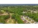 Aerial view of a neighborhood adjacent to a golf course, surrounded by lush trees and open spaces at 416 Clarion Dr, Carrollton, GA 30116