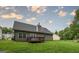 Backyard with a small deck, lush lawn and mature trees at 416 Clarion Dr, Carrollton, GA 30116