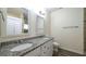 Bathroom featuring double vanities, granite countertops, and a glass shower enclosure at 416 Clarion Dr, Carrollton, GA 30116