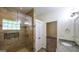Bathroom featuring a modern glass shower, granite countertop, and a doorway to the bedroom at 416 Clarion Dr, Carrollton, GA 30116