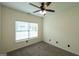 Carpeted bedroom with a bright window and a ceiling fan for comfortable living at 416 Clarion Dr, Carrollton, GA 30116