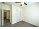 Neutral bedroom featuring a ceiling fan, closet, and carpet at 416 Clarion Dr, Carrollton, GA 30116