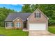 Charming single-Gathering home with stone accents, a well-manicured lawn, and a two-car garage at 416 Clarion Dr, Carrollton, GA 30116