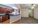 Modern kitchen with stainless steel appliances and wood cabinets open to living area at 416 Clarion Dr, Carrollton, GA 30116