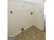 Convenient laundry room with tile flooring, wall-mounted shelf, and hookups at 416 Clarion Dr, Carrollton, GA 30116