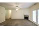 Living room with a stone fireplace, ceiling fan, and patio access at 416 Clarion Dr, Carrollton, GA 30116