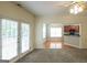 Open living room view into kitchen, French doors with backyard access, stone fireplace, and neutral walls at 416 Clarion Dr, Carrollton, GA 30116