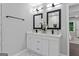 Modern bathroom with double sink vanity, marble floors, and sleek, square mirrors at 985 Columbia Dr, Decatur, GA 30030