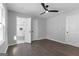 This bedroom features sleek hardwood floors, a modern ceiling fan, and an ensuite bathroom at 985 Columbia Dr, Decatur, GA 30030