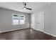 This bedroom features sleek hardwood floors, a modern ceiling fan, and bright natural light from a window at 985 Columbia Dr, Decatur, GA 30030