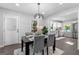 Dining room with modern chandelier, view of the backyard, and easy access to the kitchen at 985 Columbia Dr, Decatur, GA 30030