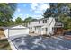 Exterior view of renovated home with detached garage, new windows, and nice backyard at 985 Columbia Dr, Decatur, GA 30030