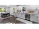 Bright kitchen featuring stainless steel appliances, white cabinets, and access to the dining area at 985 Columbia Dr, Decatur, GA 30030