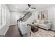 Spacious living room boasts hardwood floors, a modern staircase, and stylish furnishings at 985 Columbia Dr, Decatur, GA 30030