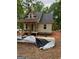 Exterior view of a home under construction showing siding, windows, porch framing and construction materials at 509 Tree Rdg, Carrollton, GA 30116