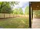 Large, grassy backyard enclosed by a wooden privacy fence with a concrete patio space at 104 Meldon Se Ave, Atlanta, GA 30315