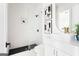 Modern bathroom features glass shower, black tile floors, and white vanity with gold fixtures at 104 Meldon Se Ave, Atlanta, GA 30315