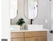 Close-up of a bathroom with dual modern sinks, gold trimmed mirrors and stylish fixtures at 104 Meldon Se Ave, Atlanta, GA 30315