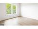 Light-filled bedroom with beautiful floors, large window overlooking a green landscape at 104 Meldon Se Ave, Atlanta, GA 30315