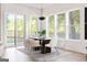 Dining room boasts a modern table setting with elegant chairs, complemented by natural light streaming through large windows at 104 Meldon Se Ave, Atlanta, GA 30315