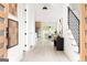 Inviting foyer with modern decor, featuring light wood floors, a stylish console table, and a staircase with iron railings at 104 Meldon Se Ave, Atlanta, GA 30315