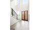 Bright and airy foyer featuring a modern staircase with black railings and a stylish front door with glass panels at 104 Meldon Se Ave, Atlanta, GA 30315