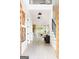 Bright and spacious foyer featuring light wood floors, modern decor, and staircase with black iron railings at 104 Meldon Se Ave, Atlanta, GA 30315