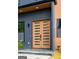 Close-up of a modern wood front door with glass inserts, complemented by sleek hardware and a secure SimpliSafe system at 104 Meldon Se Ave, Atlanta, GA 30315