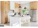 Stylish kitchen featuring stainless steel appliances, a white island with bar stools, and bright lighting at 104 Meldon Se Ave, Atlanta, GA 30315