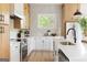 Bright kitchen featuring white cabinets, stainless steel appliances, and a quartz countertop island with a modern faucet at 104 Meldon Se Ave, Atlanta, GA 30315