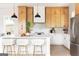 Well-lit kitchen with stainless steel appliances, a white island featuring bar stool seating, and modern pendant lights at 104 Meldon Se Ave, Atlanta, GA 30315