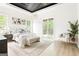 Bright main bedroom featuring a decorative ceiling, chandelier, seating area, and sliding door to the balcony at 104 Meldon Se Ave, Atlanta, GA 30315