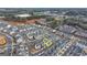Aerial view of a residential neighborhood showcasing modern townhomes with well-maintained streets and landscaping at 1006 Fendley St, Woodstock, GA 30188
