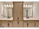 Bright bathroom featuring double vanity, modern fixtures, and a built-in linen cabinet at 1006 Fendley St, Woodstock, GA 30188