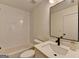 Modern bathroom with white subway tiles, vanity, and black fixtures at 1006 Fendley St, Woodstock, GA 30188