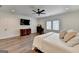 Bedroom with hardwood floors, recessed lighting, ceiling fan, and large window at 1006 Fendley St, Woodstock, GA 30188