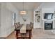 Well-lit dining room with wooden floors, a chandelier, built-in shelves and a fireplace at 1006 Fendley St, Woodstock, GA 30188