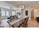 Dining room with hardwood floors, a wooden table, and a view into the living room at 1006 Fendley St, Woodstock, GA 30188